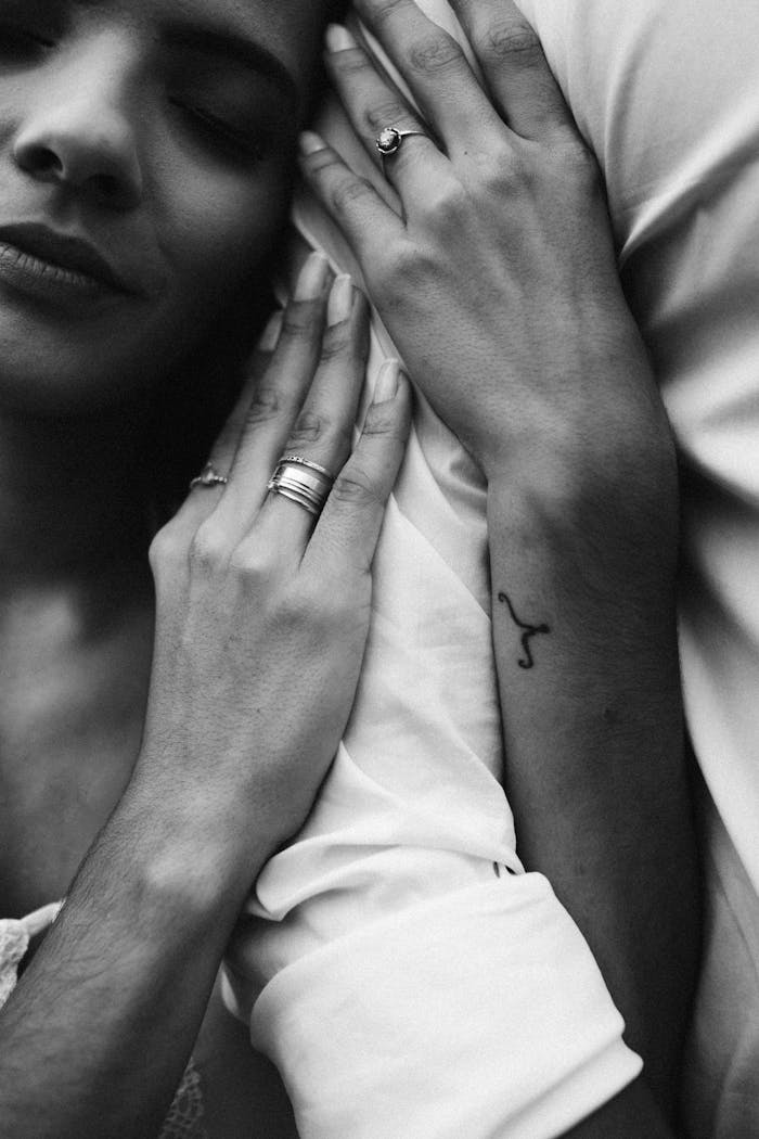 Close-up black and white image of a couple embracing, highlighting love and intimacy.